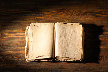 Open old book on wooden table