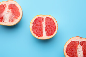 Fresh cut grapefruits on color background