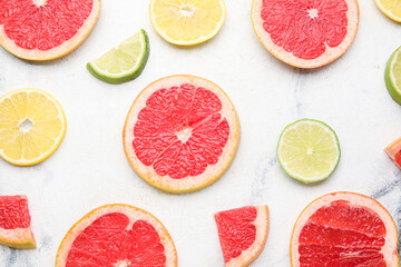 Fresh sliced citrus fruits on light background