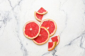 Fresh sliced grapefruit on light background