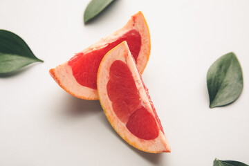 Fresh sliced grapefruit on white background