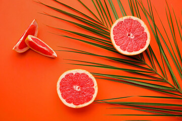 Fresh sliced grapefruit on color background