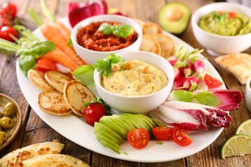 variety of fresh vegetaables and hummus dips