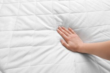 Female hand on soft orthopedic mattress
