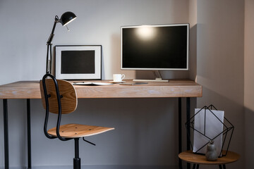 Comfortable workplace with lamp and modern computer