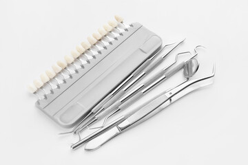 Dentist's tools and teeth color samples on white background