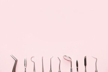 Dentist's tools on color background