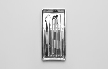 Tray dentist's tools on light background