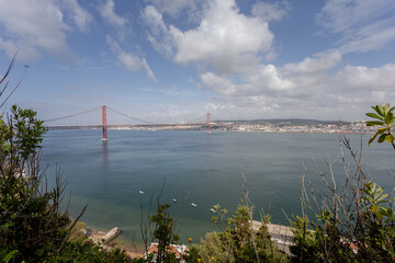 wide panorama overlooking the river and the big bridge on April 25 in Lisbon, Portugal