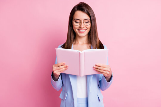 Photo of young attractive girl happy positive smile read novel story isolated over pink color background