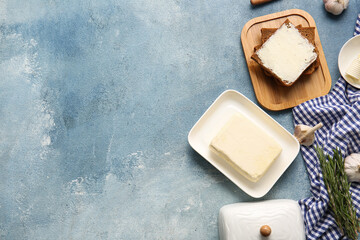 Composition with fresh butter and bread on color background