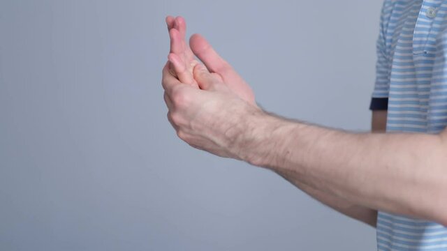 A man massages a joint in his hand. Close up. Carpal tunnel syndrome, arthritis, neurological disease concept. Numbness of the hand. video stock footage. Slow motion