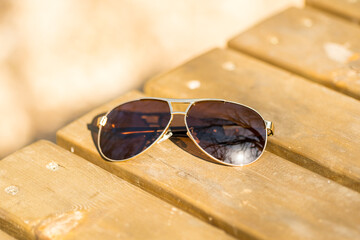 Fototapeta na wymiar Aviator sunglasses model with big brown lenses shoot outside in a summer day closeup . Selective focus. High quality photo