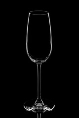 Glass empty champagne goblet on black background