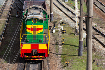 Colorful diesel locomotive maneuvers on the railway track.