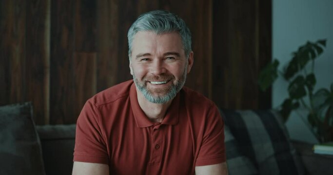 Smiling man look at camera talk make live video conference call online chat. Apartment, vlog videocall, relaxed, conference speaking, communication channel. Slow motion