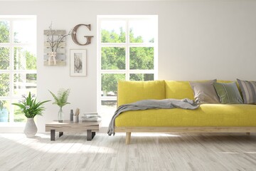 Fototapeta premium White living room with sofa and summer landscape in window. Scandinavian interior design. 3D illustration