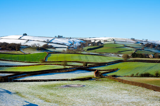 Snow on colourful green and white Shropshire Hills, near Clun, in December for Christmas. Beautiful hilly British landscape, England, UK, stock photo