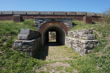Fototapeta na wymiar Colonial Arched Brick Opening to Wetlands at Fort Mifflin on Sunny Spring Day