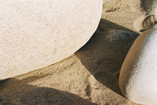 Curved rocks in the sun, casting a shadow