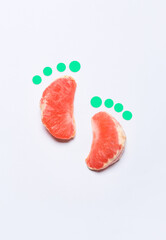Creative composition with slices of grapefruit on white background