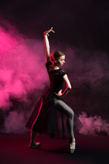 Obraz na płótnie Canvas Beautiful young ballerina on dark color background