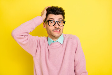 Photo of young man clueless confused shrug shoulders no answer isolated over yellow color background