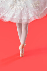 Beautiful young ballerina on color background