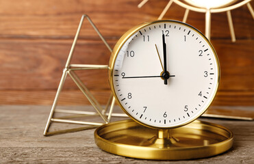 Alarm clock on wooden background, closeup