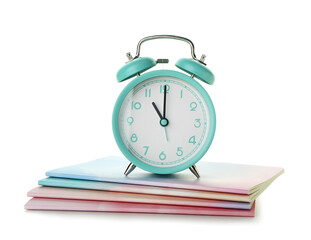 Alarm clock and notebooks on white background