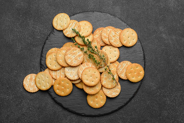 Plate with crackers on dark background