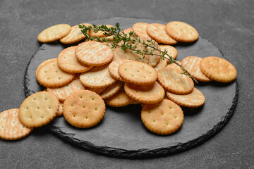 Plate with crackers on dark background