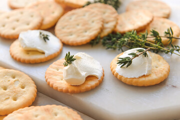 Crackers with cream on light background