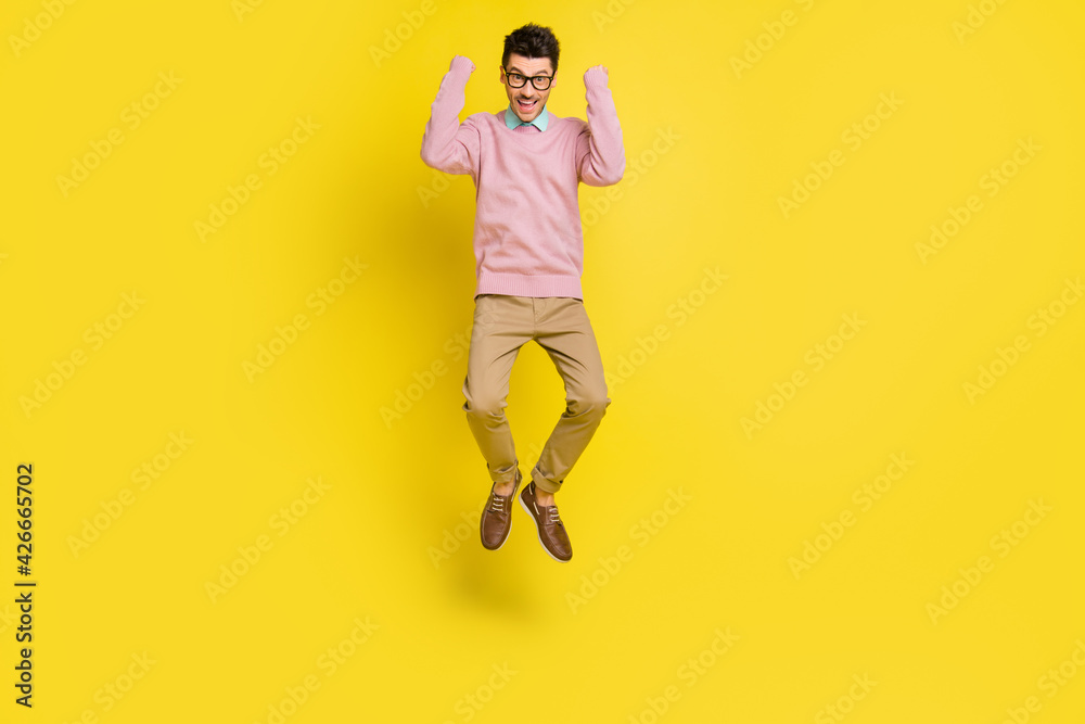 Poster Full body photo of young excited man happy positive smile excited rejoice win victory jump up isolated over yellow color background