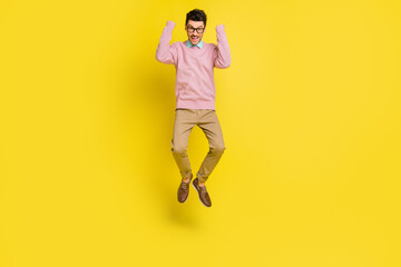 Fototapeta na wymiar Full body photo of young excited man happy positive smile excited rejoice win victory jump up isolated over yellow color background