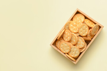 Box of crackers on color background