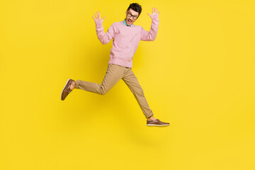 Fototapeta na wymiar Full size photo of young cheerful man happy excited have fun jump up wave hello isolated over yellow color background