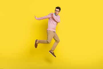 Fototapeta na wymiar Full size photo of young shocked amazed surprised man running in air from problems isolated on yellow color background