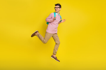 Fototapeta na wymiar Full size profile side photo of young happy excited smiling man with backpack look copyspace isolated on yellow color background