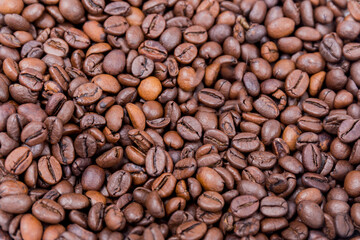 coffee composition, close-up of two cups of coffee one orange and one green with their plates full of coffee beans on a wooden surface