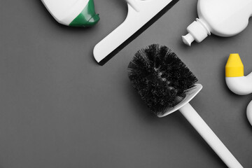 Set of cleaning supplies on dark background