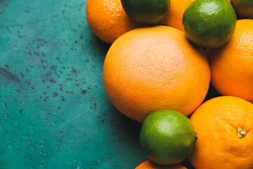 Fresh citrus fruits on color background