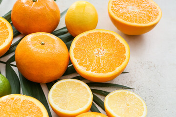 Fresh citrus fruits on light background