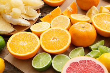 Fresh citrus fruits on wooden background