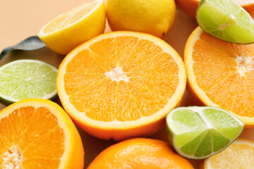 Fresh citrus fruits on color background