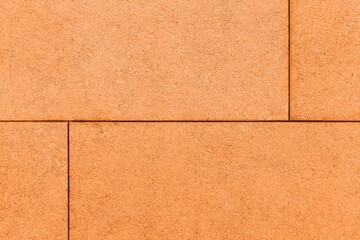 Building exterior brown granite block wall texture and background seamless