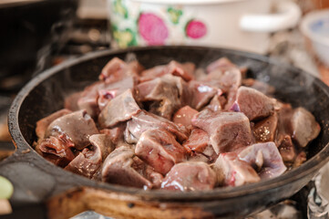 Fried veal liver in a pan. Braised cow and pork liver