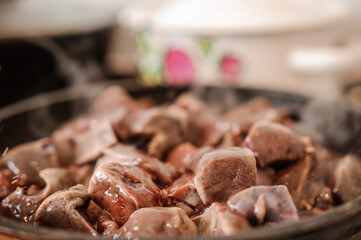Fried veal liver in a pan. Braised cow and pork liver