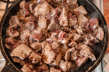 Fried veal liver in a pan. Braised cow and pork liver