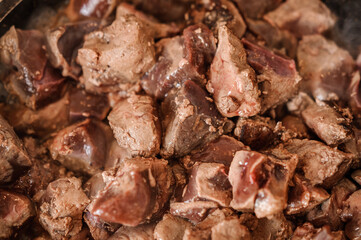 Fried veal liver in a pan. Braised cow and pork liver